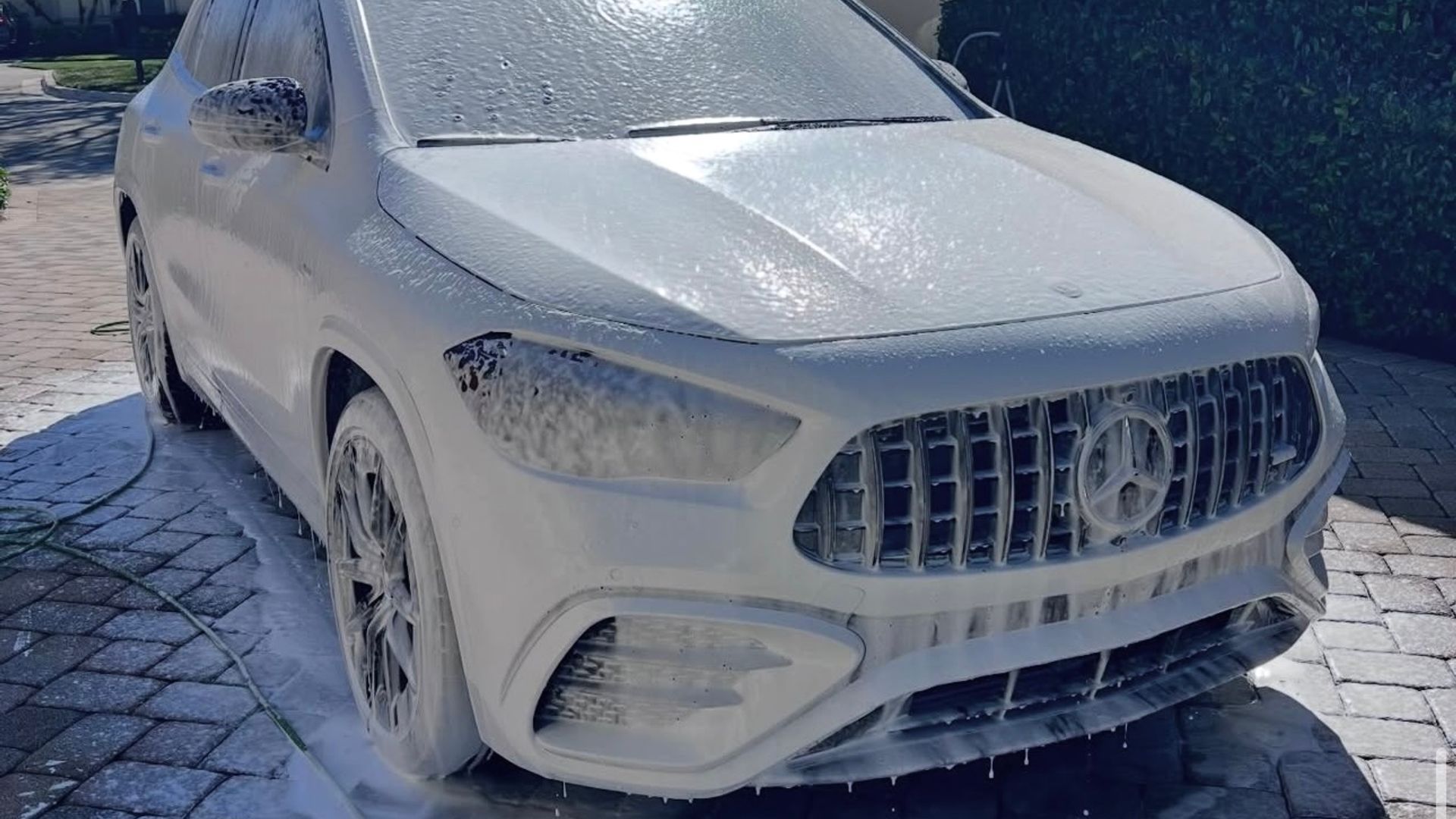 Mercedes-AMG covered in snow foam during the pre-wash