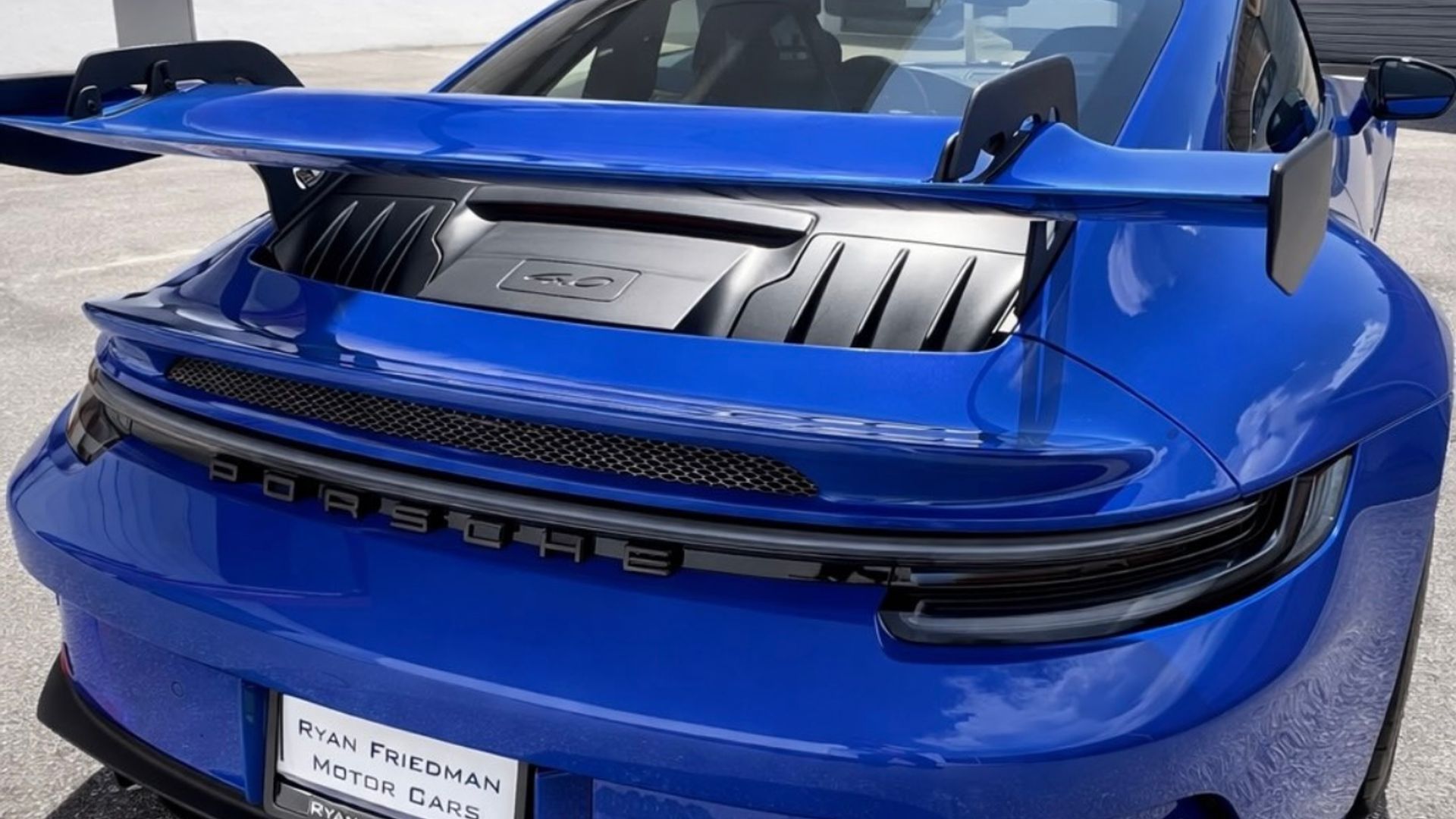 Rear of a blue Porsche 911 GT3 with its swan-neck wing