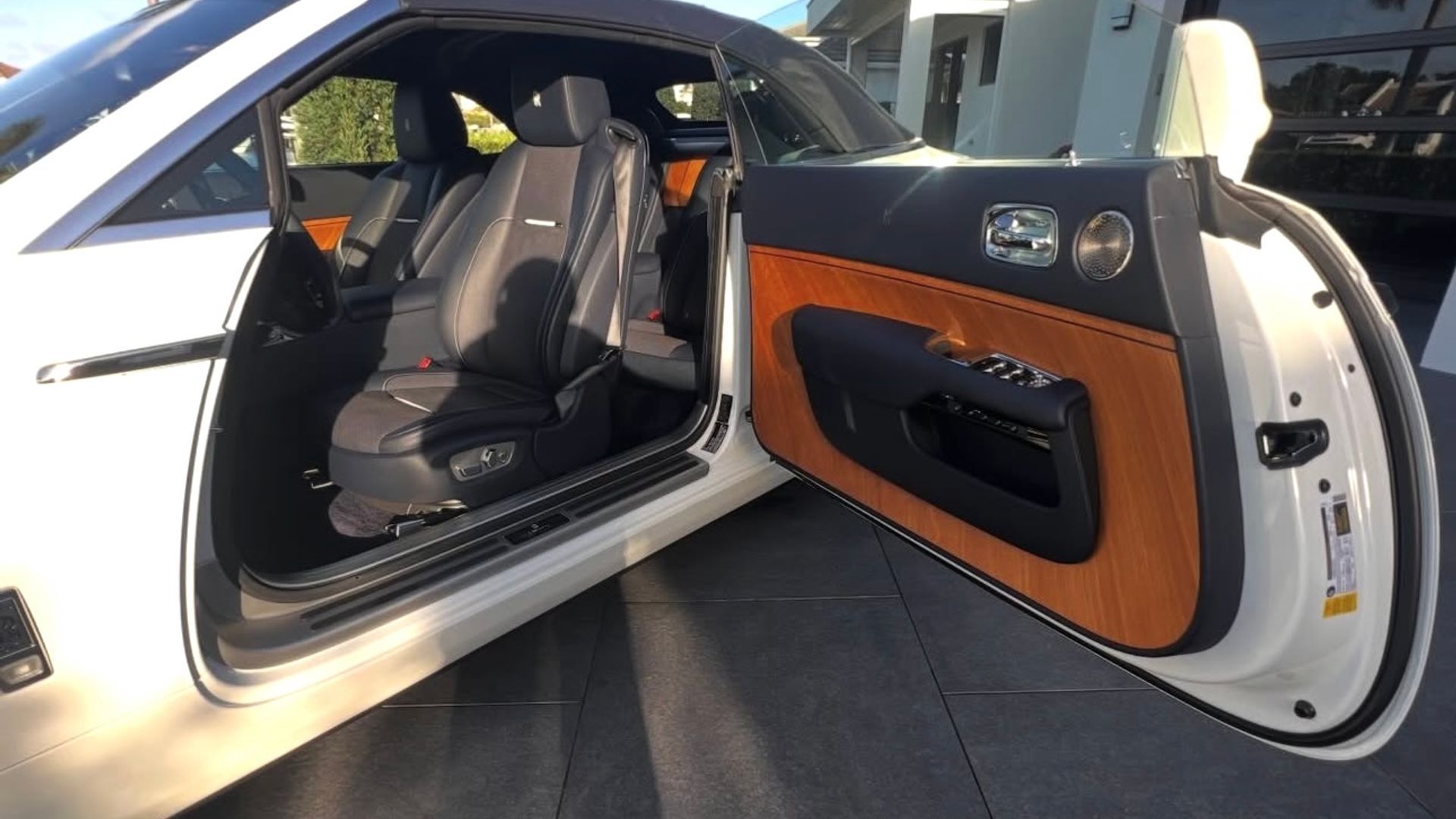 Rolls-Royce door open, showing the leather and wood interior